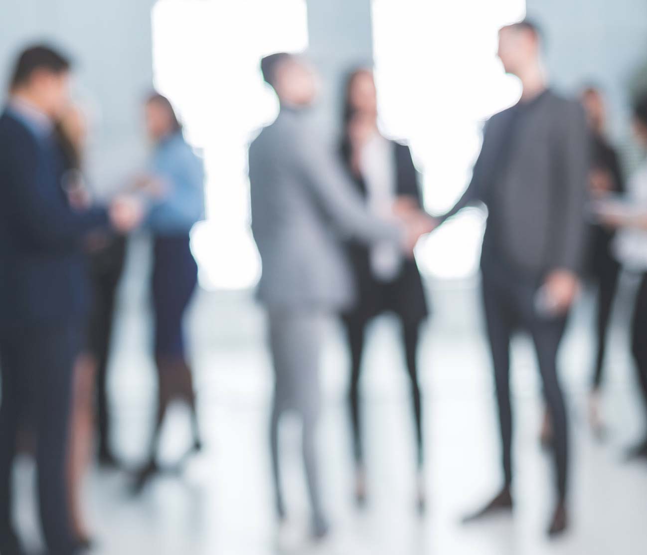 blurred people shaking hands and greeting each other